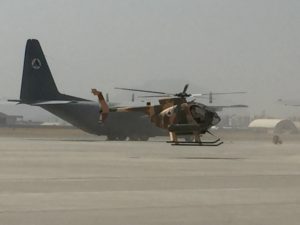 Afghan attack helicopter with c-130 in background